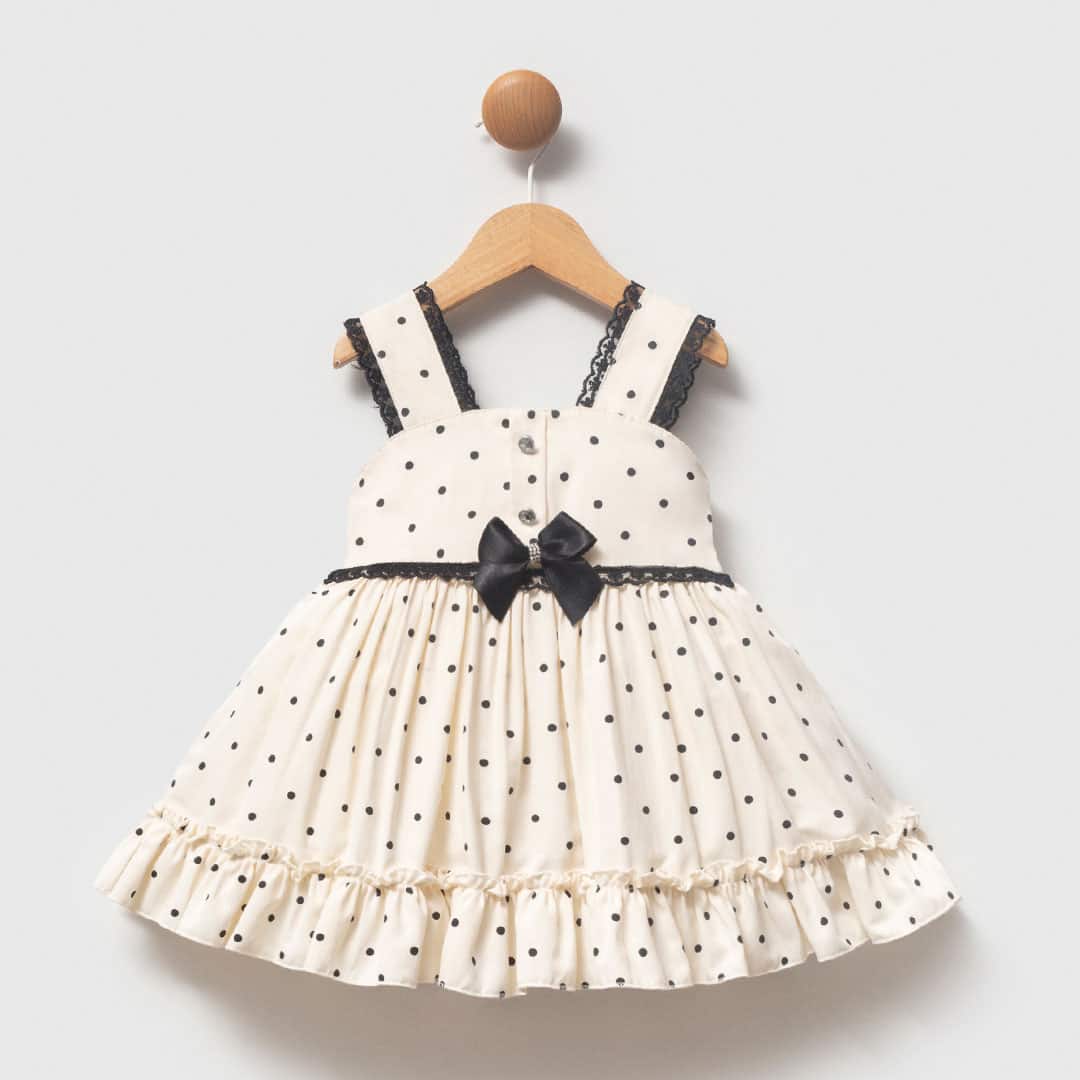 βρεφικό φόρεμα πουά εκρού με μαύρο φιόγκο για κορίτσι